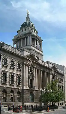 Exterior of court building with statue of Lady Justice on top