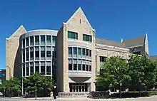 Modern four-story building of smooth stone and concrete