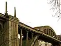 Looking up at Oregon City Bridge from Frontier Street in West Linn, in 2007, before lights were reinstalled on the obelisks