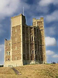 A circular tower with projecting square towers attached