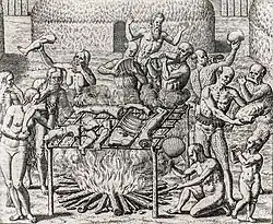 Woodcut showing 12 people holding various human body parts carousing around an open bonfire where human body parts, suspended on a sling, are cooking.