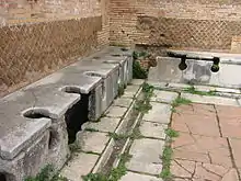 Image 39Public toilets (latrinae) from Ostia Antica (from Roman Empire)