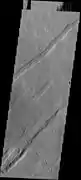 Oti Fossae, as seen by THEMIS.  These parallel graben are found on the northeastern side of Arsia Mons; they are in line with the NE/SW trend of the three volcanoes in Tharsis.