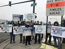 PASS members outside holding signs that say Don't Gamble with Aviation Safety and Aviation Safety is Our Only Business.