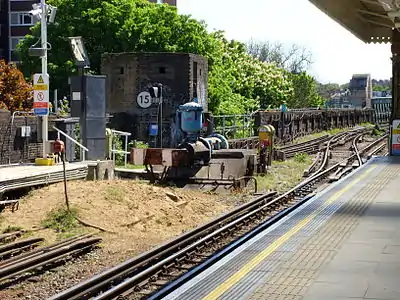 Southern end of the platforms at Putney Bridge station, showing the reversing siding, the World War 2 pillbox defending the bridge, and the northern tip of the bridge