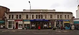 A white building with signs reading "METROPOLITAN RAILWAY" and "PADDINGTON STATION" in large lettering cast into the stonework above the entrance