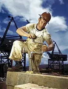 Carpenter using a hand-powered brace to drill a hole