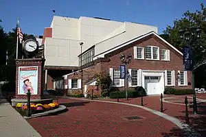 Entrance to the theater Paper Mill Playhouse with the poster to a play outside it