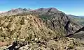 Parker Peak seen from Rush Creek Trail near Spooky Meadow on Carson Peak. Parker is the reddish peak centered in the distance.