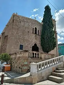 A stone building with a cross on top