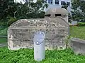 A memorial plaque established by Singapore's National Heritage Board (NHB) in front of the pillbox commemorating the history of the structure.