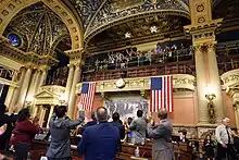 Legislators cheer and acknowledge nurses in upper gallery