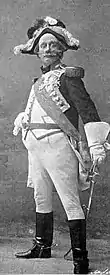 White man in French military costume, striking exaggerately belicose pose