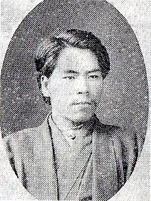 Black and white photograph of a man wearing a kimono