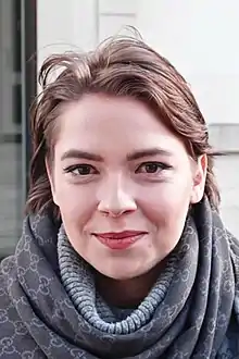 Headshot of Janečková, outside, looking at the camera