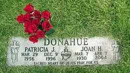 A flat gravestone with a bouquet of roses