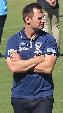 Male football coach crossing arms