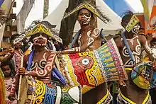 Papuan tifa drum being played in a Suling Tambur combination at a Sing-sing.