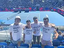 Four people wearing ‘Where is Peng Shuai?’ white t-shirts with black lettering at the Australian Open.