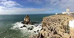 The cape's lighthouse to the right, Nau dos Corvos, (Carrack of Crows), to the left and the Berlengas in the far background.