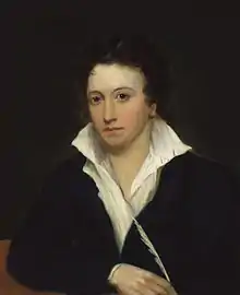 Half-length portrait of man wearing a black jacket and a white shirt, which is askew and open to his chest.