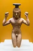 Ancient Greek perfume bottle in shape of an athlete binding a victory ribbon around his head; circa 540s BC; Ancient Agora Museum (Athens)