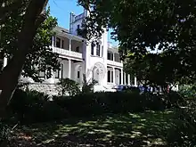 Image of the Peter Clarke Art Centre, a white, double-story building with arches.