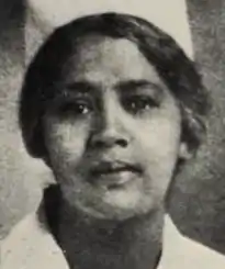 An African-American woman, wearing a nurse's cap