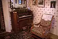 Interior of the Pickett House showing the organ and a rocking chair