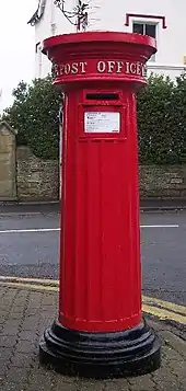 Photo of a Victorian cast iron readitional red letterbox still in use