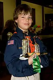 Image 1A happy Cub Scout holds a winning pine car