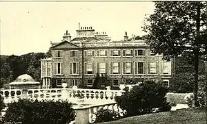 black and white photo of big house with lots of windows