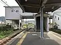 The station platform looking west. Note the stairwell leading to the station building above the tracks and also the station entrances (stairwells) on both sides.