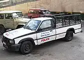 Mazda Courier pickup truck, in the background Toyota Land Cruiser FJ40 Hard Top