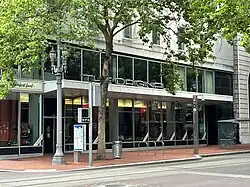 Photograph of a street level restaurant with many windows