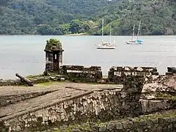 Ruins of stone fortifications near water.