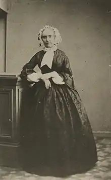 Photograph of Henriette Renan standing in 19th-century costume