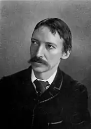 Black and white portrait of a white man with a mustache, wearing a jacket and tie