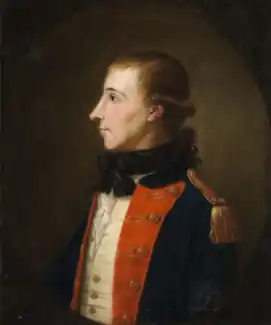 Portrait of a man in profile from the waist up, facing left, dressed in a military uniform