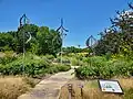 The Missouri Botanical Garden Prairie Garden in 2023. It includes stone paths and metal animal silhouettes.