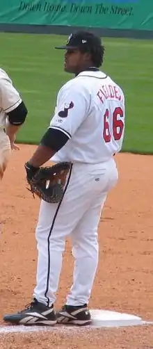 A baseball player in white