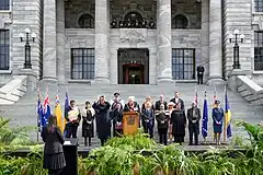 A group of state officials gathered outside Parliament House accompanied by heralds