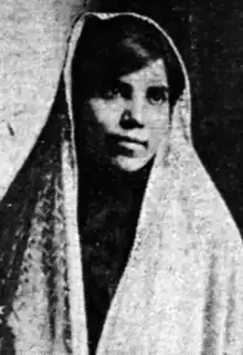 A young Persian woman, with dark glossy hair parted at the side, wearing a head-covering veil or shawl.