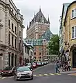 The Château Frontenac is located a block south of the building. The two are separated by Place d'Armes