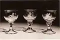 Three out of 10 goblets engraved by Alison Geissler and presented to Her Majesty Queen Elizabeth by the High Constables and the Guard of Honour of Holyrood House for the Coronation in 1953. The wineglasses are part of the Royal Collection. © Studio Swain, Glasgow.