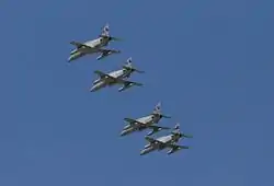 Four monoplane aircraft flying in close formation. The aircraft are painted grey and have been photographed from below.