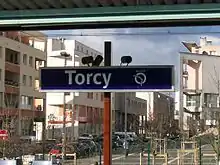 Sign indicating the name of the station  (with overlooking the neighbourhood)