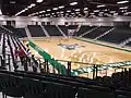 Renovated gym floor inside of Harrison HPER Complex with seats installed