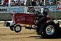 Tractor performing a wheelie