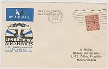 Envelope with an art deco RAS logo and 1½d postage stamp. The typed address reads "A Phillips, Railway Air Services, L.M.S. Office, Piccadilly, Manchester"